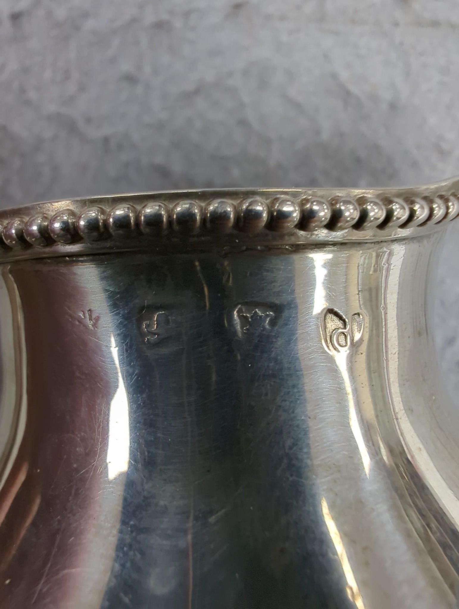 A George III silver inverted pear shaped cream jug, London, 1779, 31.1cm, maker's mark rubbed.